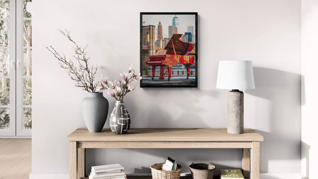 Framed cityscape wall art of a red piano on a Brooklyn Bridge backdrop, designed by Harlem-based artist Corey Wesley, part of the Urban Pulse Collection.