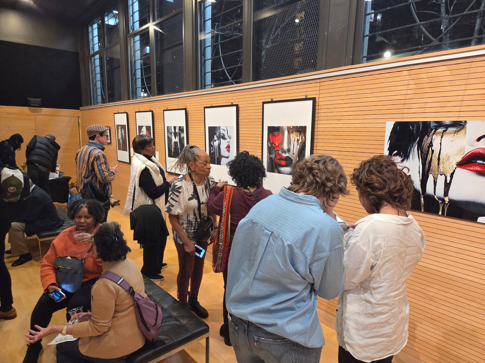 Guests exploring the Unapologetic Faces exhibition during Corey Wesley’s debut New York City presentation of one of one contemporary works.