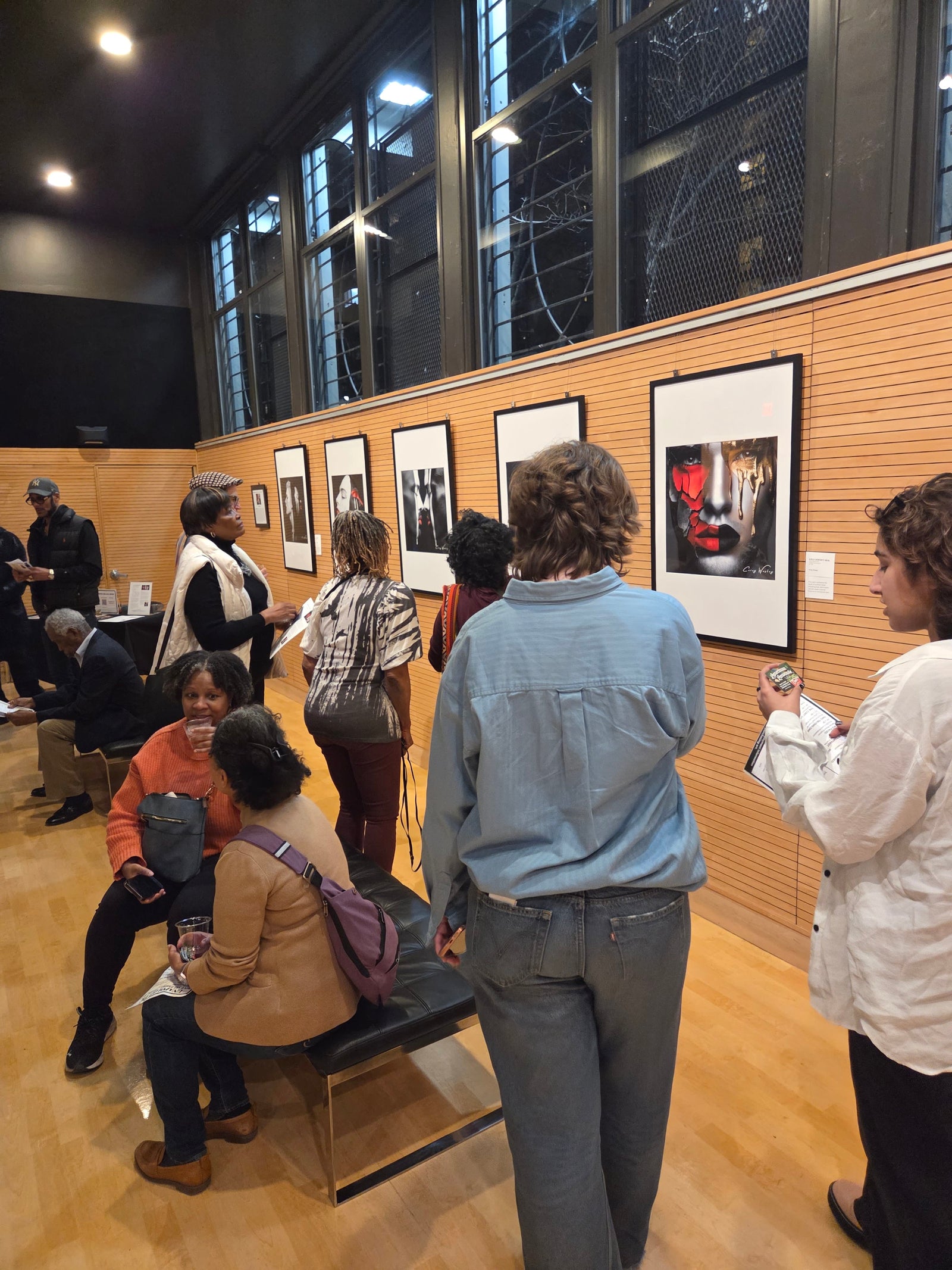 Guests viewing the Unapologetic Faces collection at Corey Wesley’s debut exhibition. The faces are archetypes, not any one person.