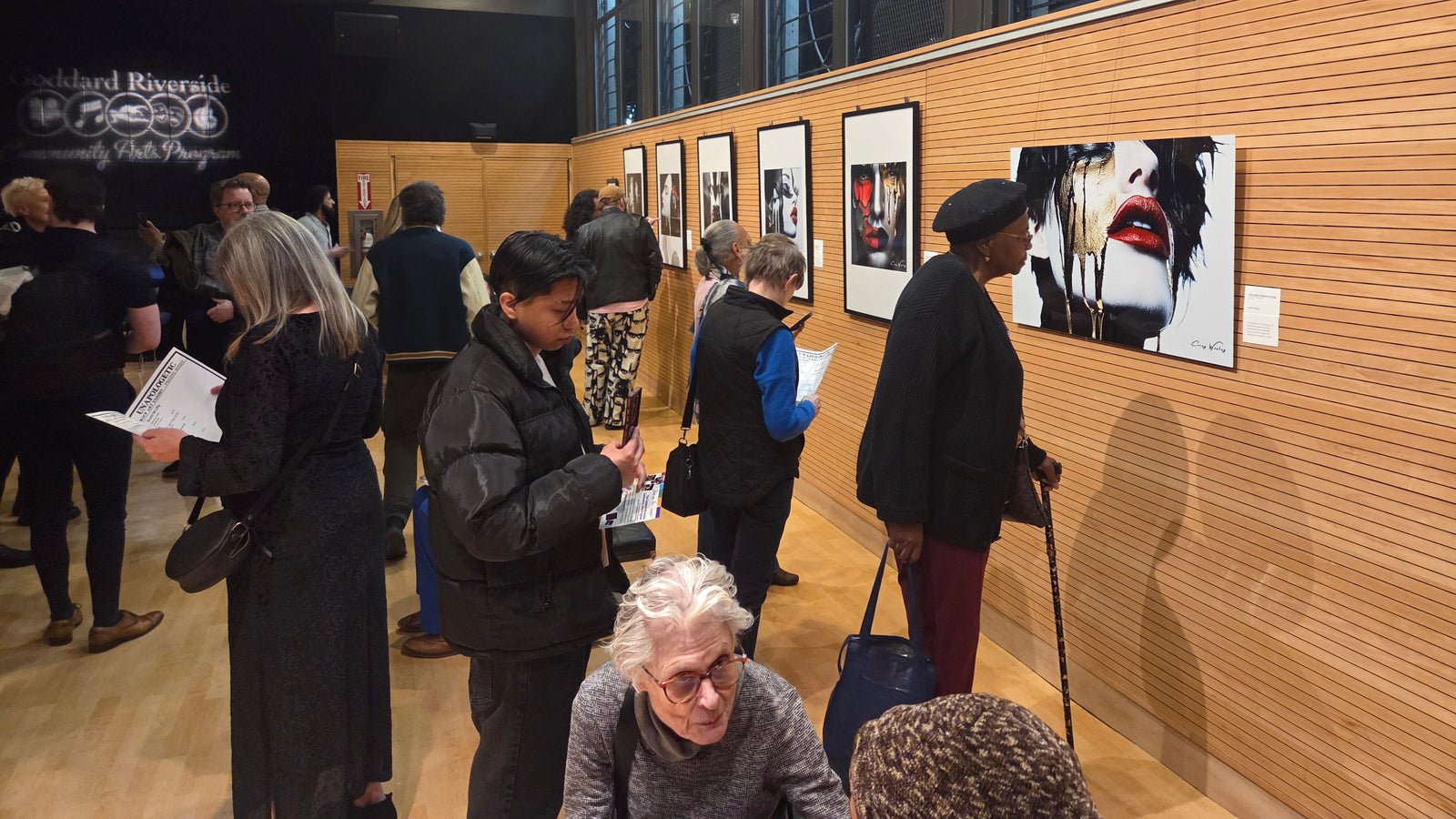 Visitors engaging with the Unapologetic Faces series at Corey Wesley’s debut exhibition. The collection holds identity, vulnerability, and the story a face carries before a word is spoken.
