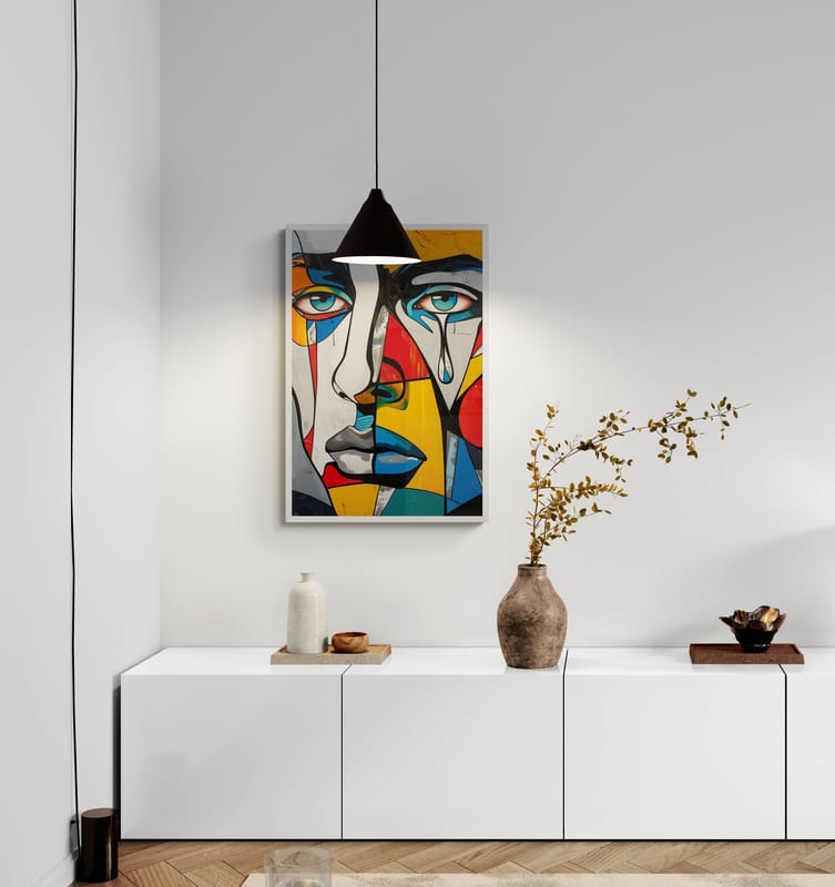 Modern living room with a framed abstract portrait by Corey Wesley hanging above a minimalist white cabinet, adding bold color and personality to the space.